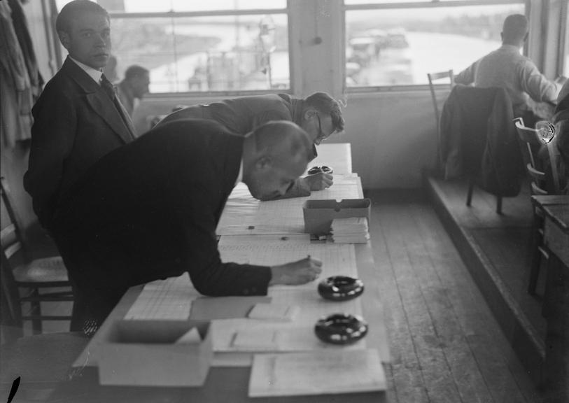 Men at work in the racing track office.