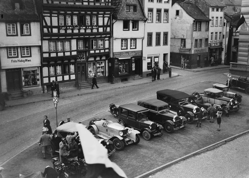 Motorcycles and cars in a town centre