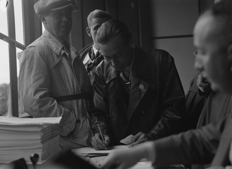 Men in a racing track office