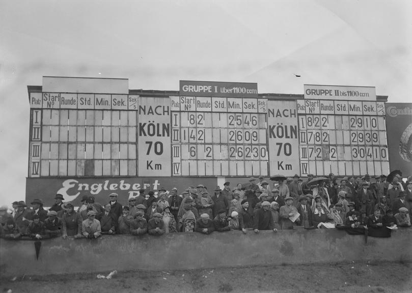 Crowds in front of a scoreboard