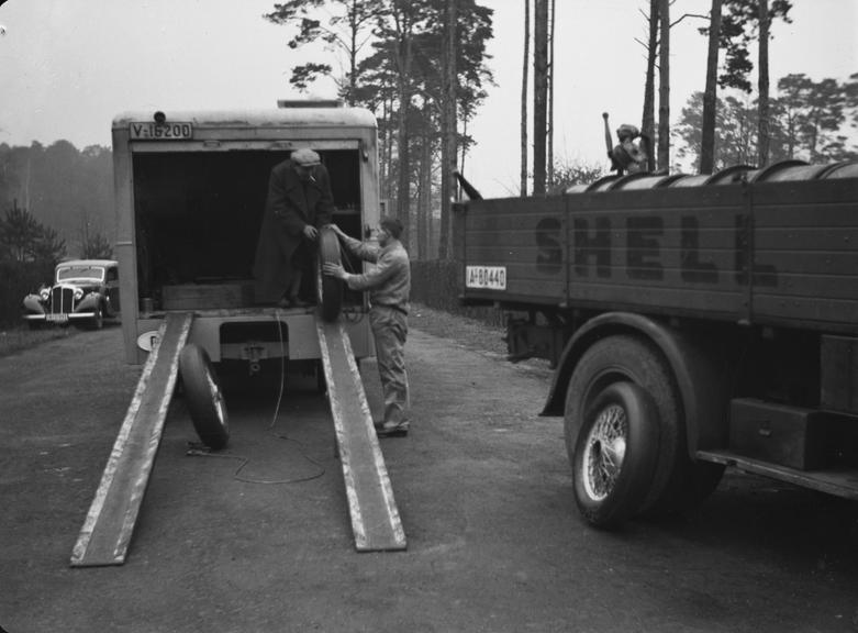 Men unloading tyres from a lorry