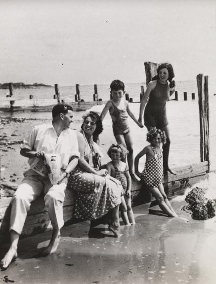 Family sit on breakwaters