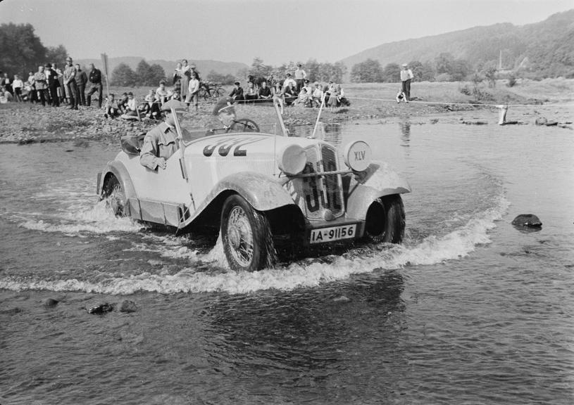 Car driving through river