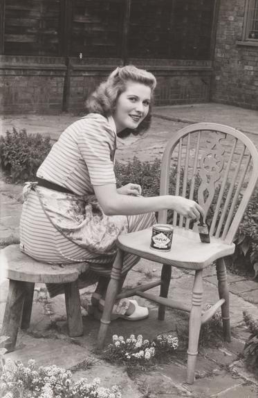 Woman varnishing a chair