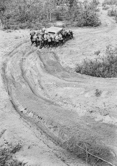 Soldiers pushing a car