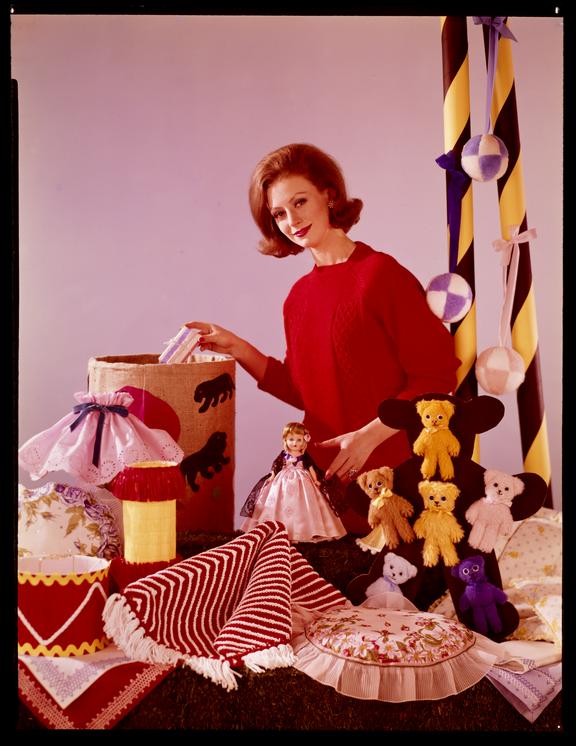 Woman in red jumper with homemade craft gifts