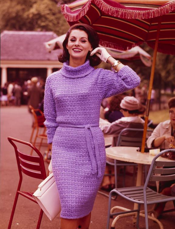 Smiling woman poses by outdoor cafe