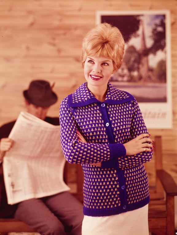 Woman poses, man with newspaper in background