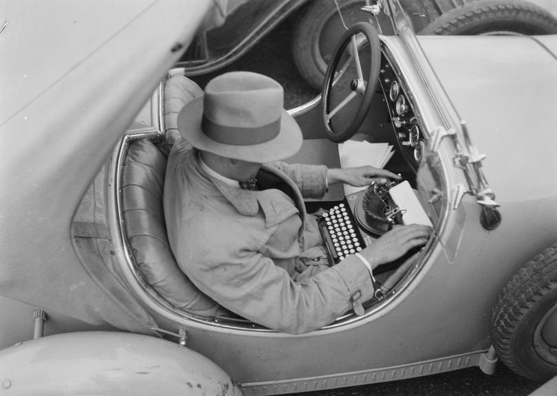 Man typing in a car