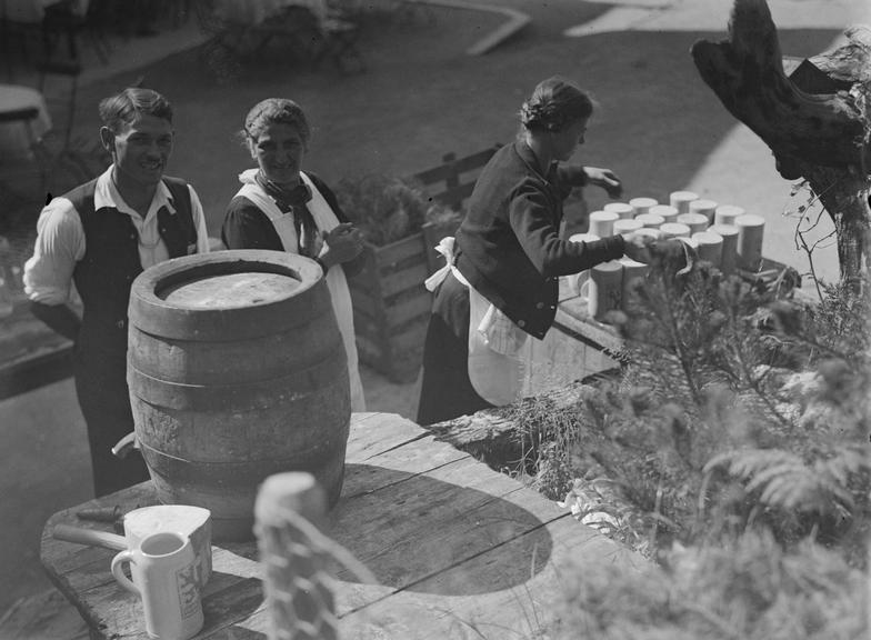 Workers beside beer keg and tankards