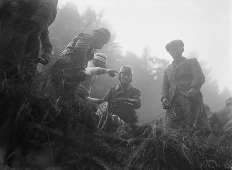 Men looking over a mountain ledge