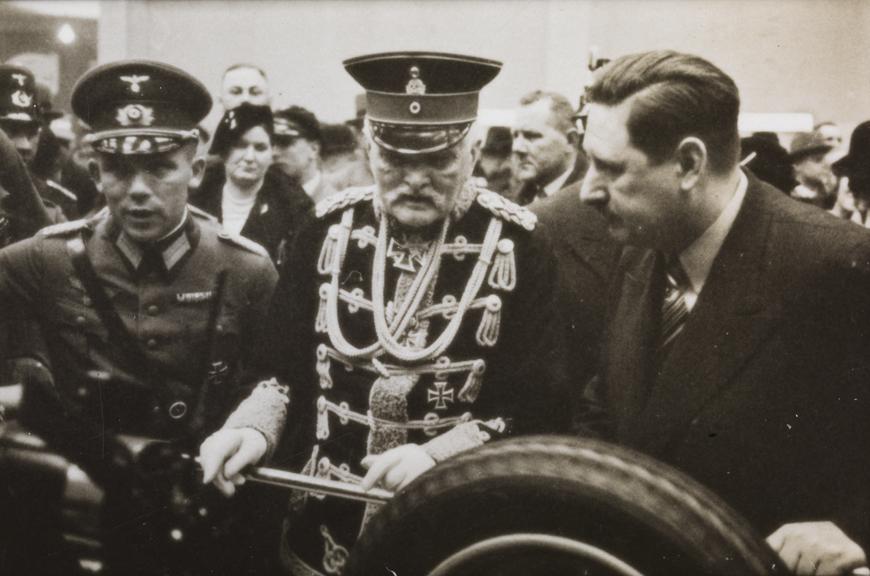 Military officer inspects a car