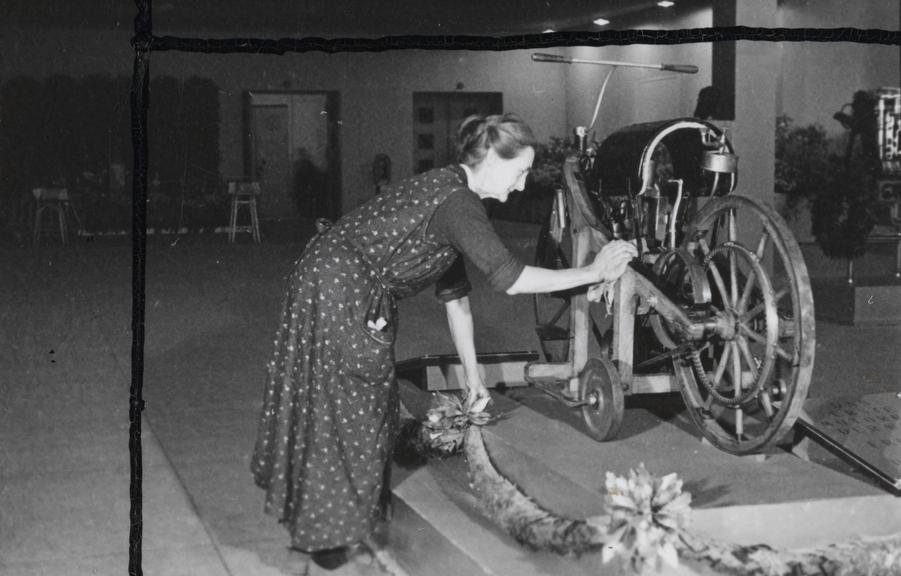 Women cleaning a Daimler motorcycle