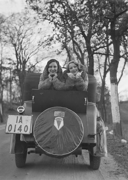 Two women posing in the boot of a DKW car