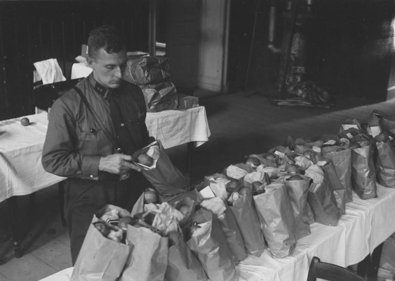 Nazi soldier fills lunch bags for car race entrants