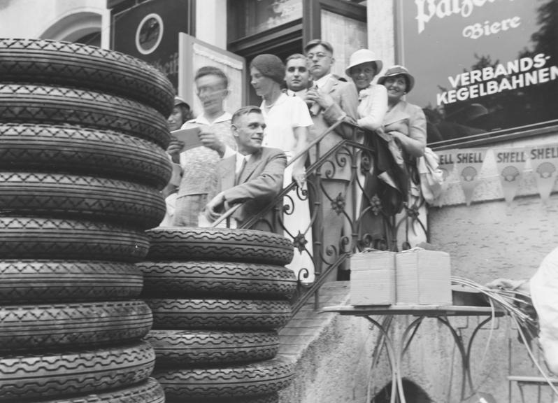 Crowd gather on steps to watch car race