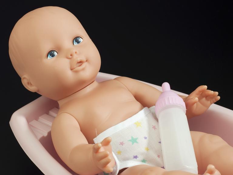 Infant doll with feeding bottle and baby bath used in