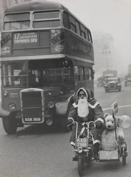 Father Christmas riding his motorbike on Oxford Street