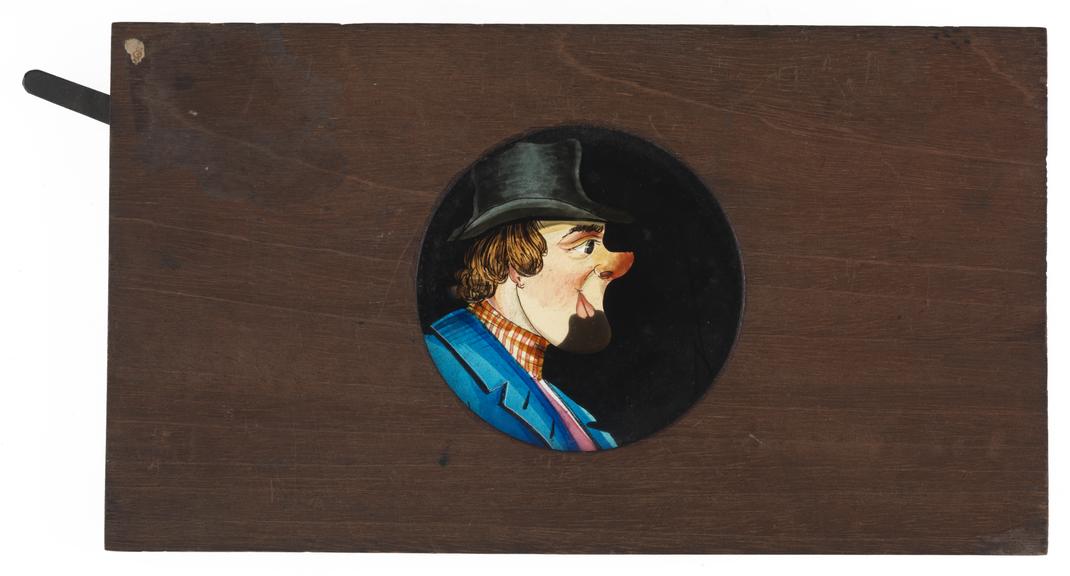 Hand coloured lantern slide of a man with a red nose wearing a