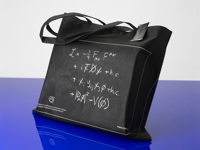 Black fabric bag with equations describing how particles get