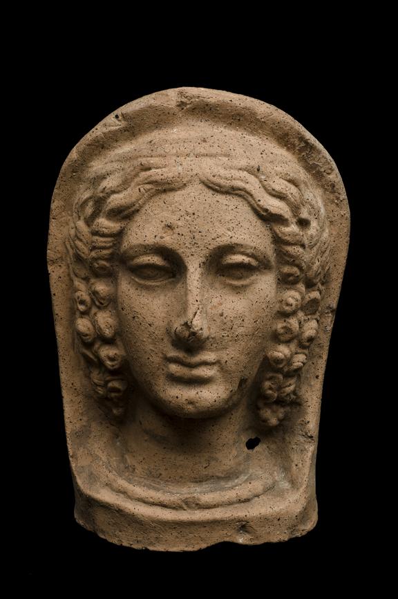 Votive female head, back not modelled, terracotta