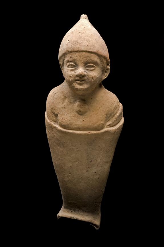 Votive figure of swaddled infant wearing cap and amulet