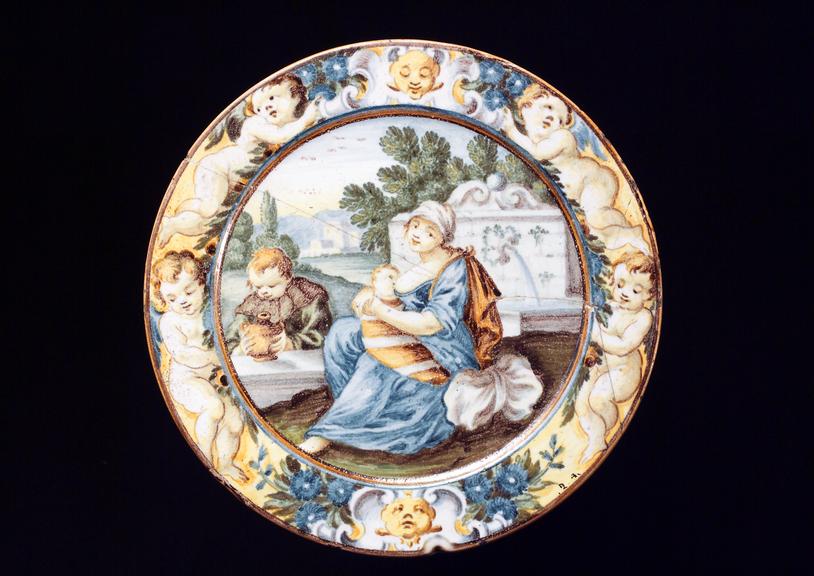 Tin-glazed earthenware plate, showing breast feeding, Italian