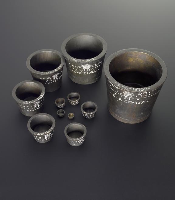 Electrotype copy of a set of 13 Troy weights from 256 oz to 8