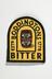 Embroidered badge bearing Boddingtons logo
Photographed on a