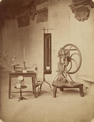 Photograph of Delenil's Reciprocating Vacuum Punch and two manometers