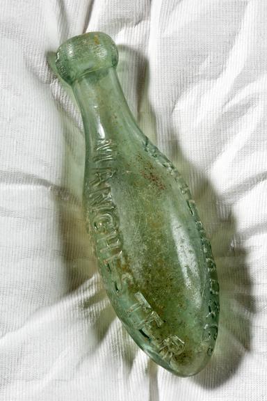 Bottle photographed straight on view on a white background.