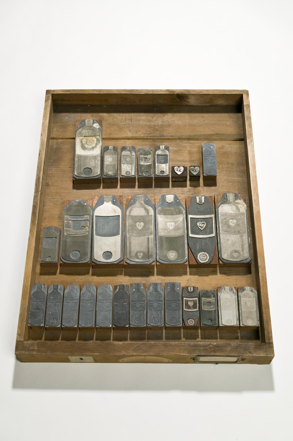 Wooden drawer tray containing printing blocks