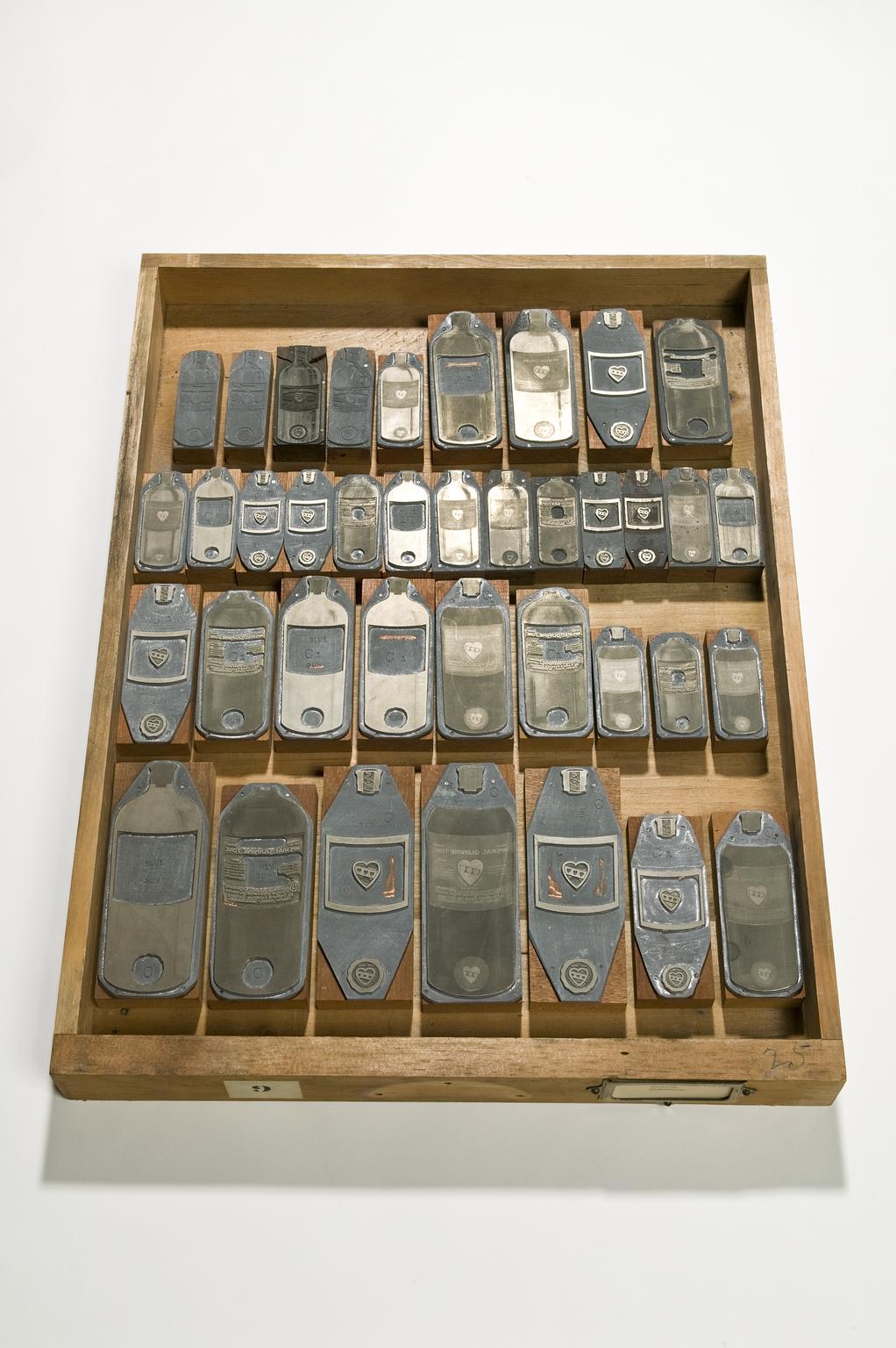 Wooden drawer tray containing printing blocks