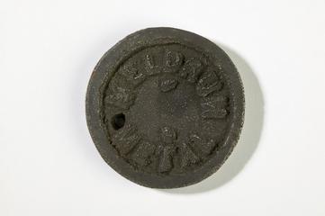 Cast metal disc sample of Meldrum metal