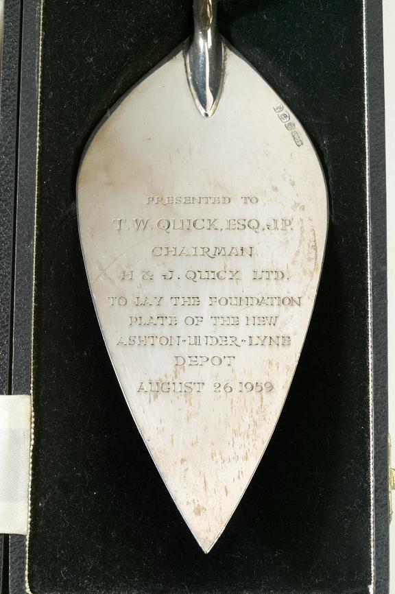 Silver trowel marked with details of Quick's