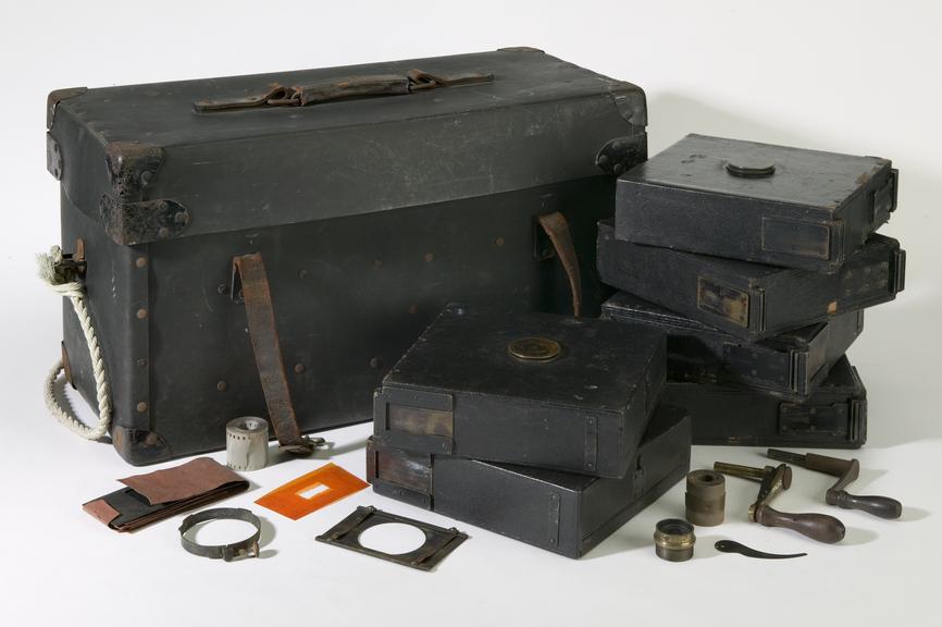 Black tool box containing various tools and film reel holders