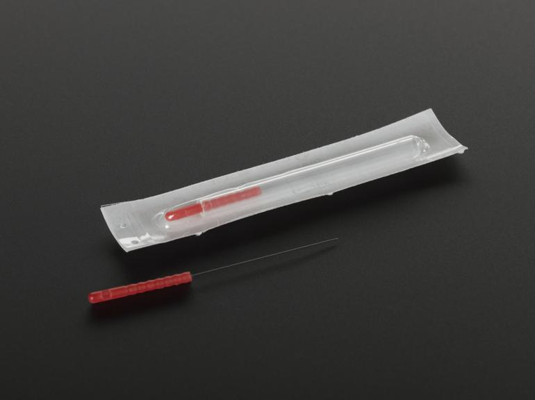 Two acupuncture needles with red holders in sterile packaging Science