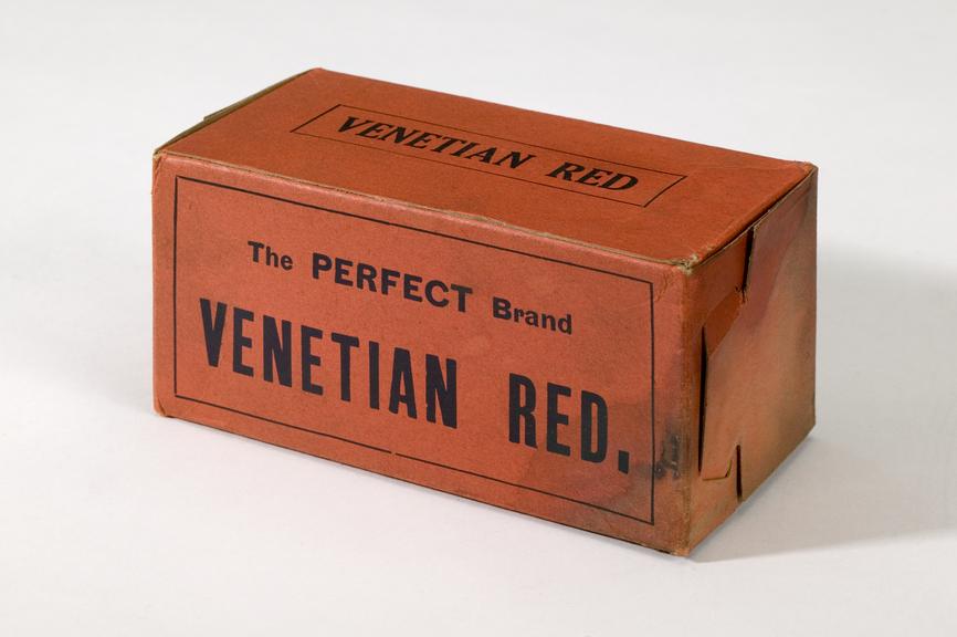 Box of Venetian Red pigment.
Photographed on a white background.