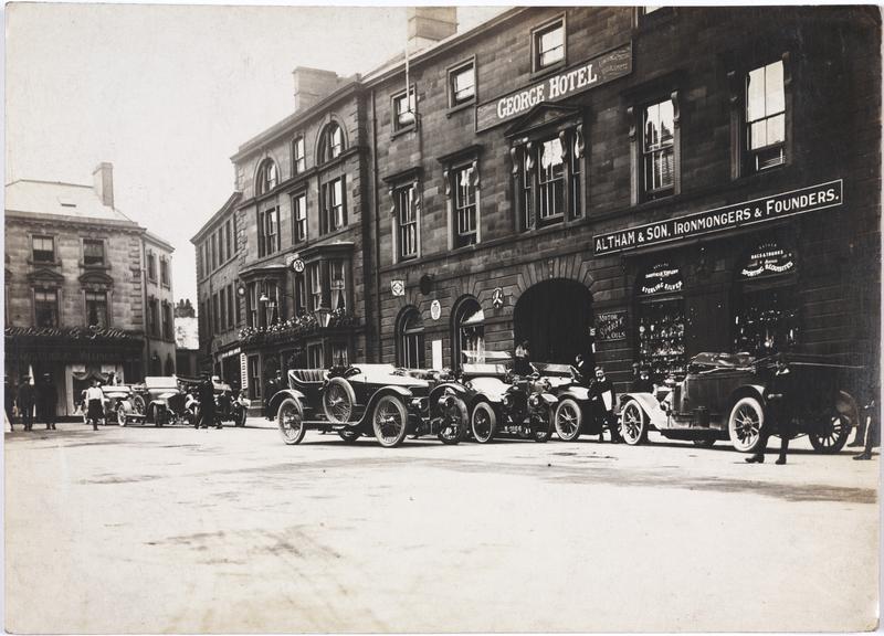 Photograph of some cars outside the Geroge Hotel