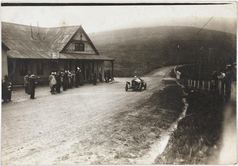 Photograph of a Sunbeam car passing the Bungalow Hotel