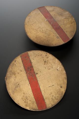 Zinc discs, painted one side white with broad red line across the centre