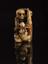 Netsuke in form of skeleton with Tanuki the badger holding peach
