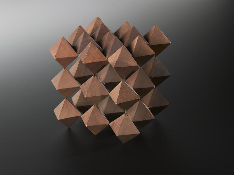 Crystal structure represented by a wooden assemly of three