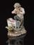 Porcelain figure depicting a satyr playing pipes to a child in