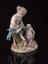 Porcelain figure group depicting a faun feeding her young with