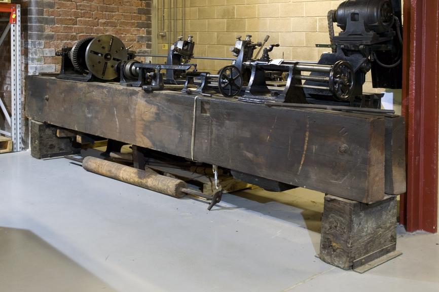 Wooden bed lathe; wooden support beams with cast iron lathe