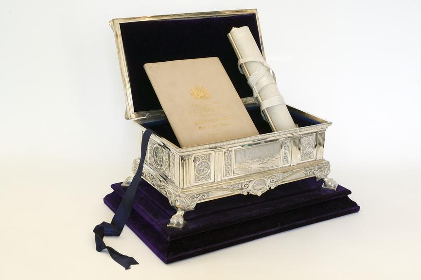 Silver presentation casket containing illuminated scroll