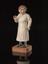 Wooden statue depicting a female doctor holding a stethoscope