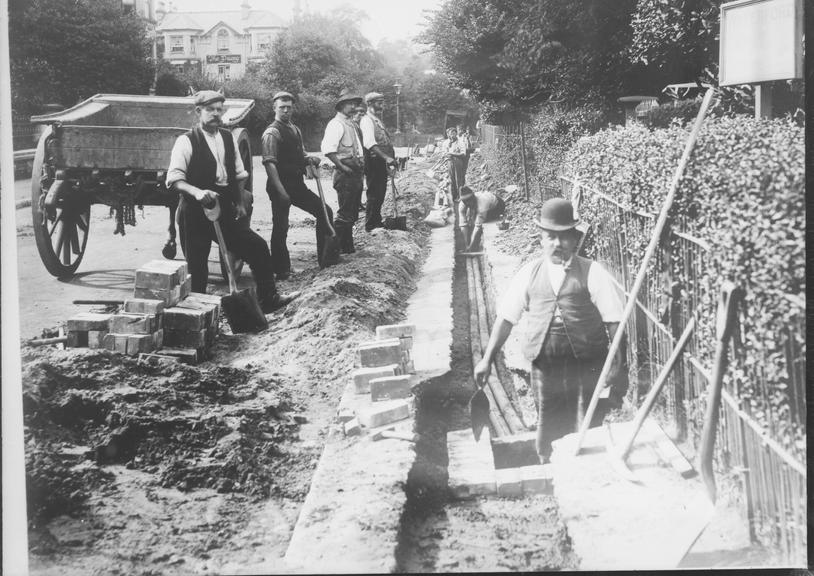 Works photographic negative of men laying cable, Bournemouth