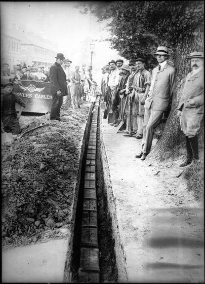 Works photographic negative of men laying cable, Swindon